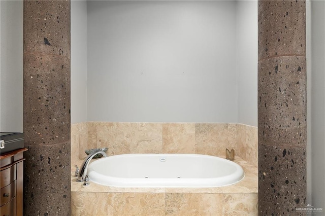 bathroom featuring tiled tub