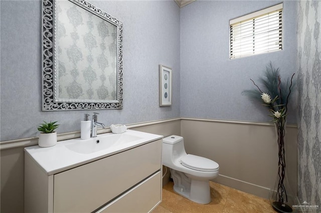 bathroom featuring tile patterned flooring, vanity, and toilet