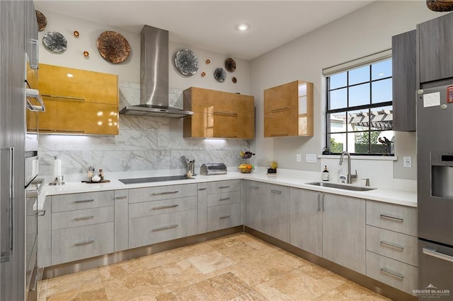 kitchen featuring black electric stovetop, backsplash, sink, wall chimney range hood, and stainless steel fridge with ice dispenser