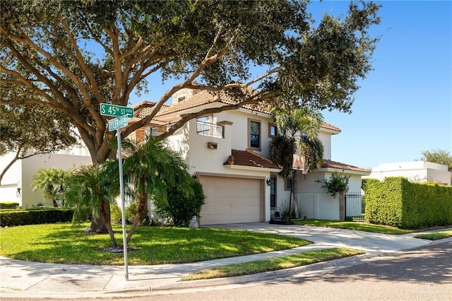 mediterranean / spanish-style house featuring a garage and a front lawn