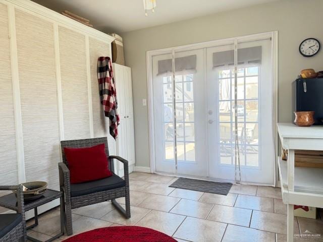 doorway featuring light tile patterned flooring and french doors