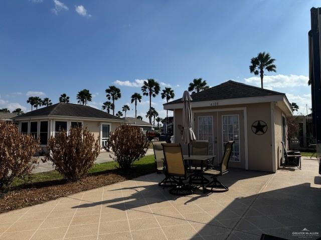 back of property featuring french doors and a patio area