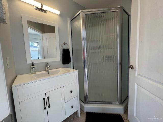 bathroom featuring vanity and a shower with shower door