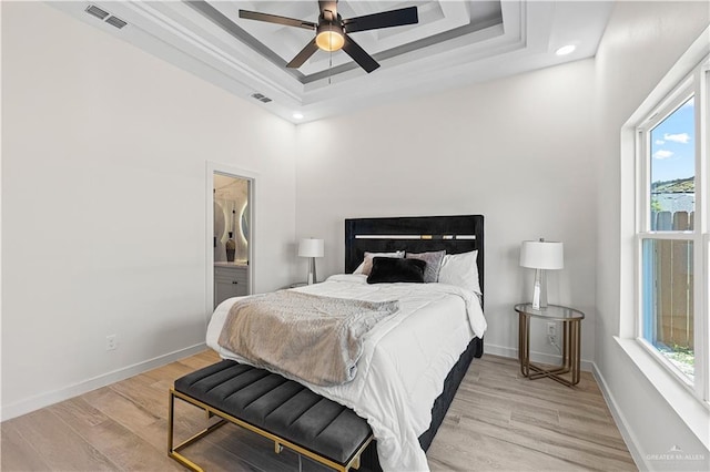 2229 N Ruby St, Edinburg, TX 78541 - bedroom with a raised ceiling, light wood-type flooring, baseboards, recessed lighting, and connected bathroom