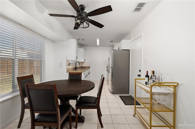 dining room with sink, ceiling fan, and light tile patterned floors