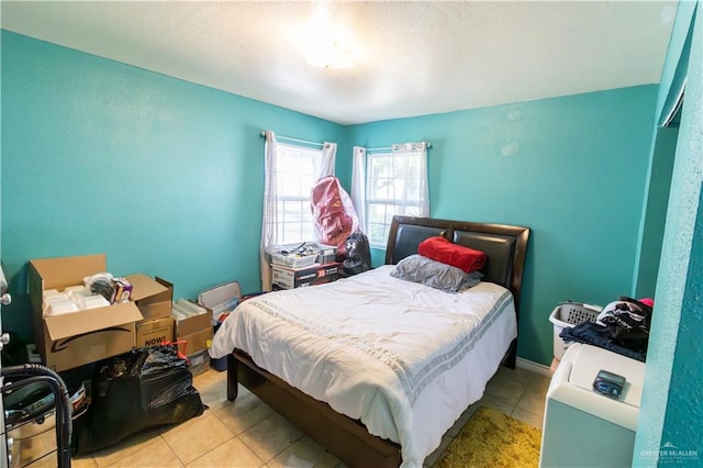 bedroom featuring light tile patterned flooring