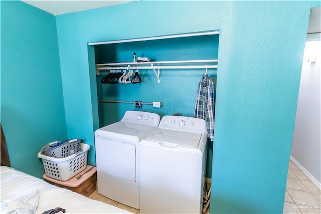 laundry area featuring washer and dryer and light tile patterned flooring