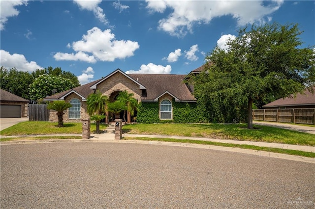 view of front of home featuring a garage and a front lawn