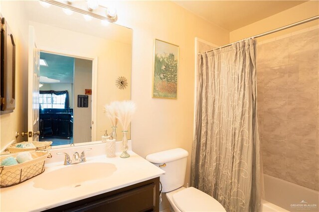 full bathroom featuring vanity, toilet, and shower / bathtub combination with curtain