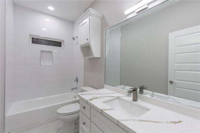 full bathroom with tiled shower / bath combo, vanity, and toilet