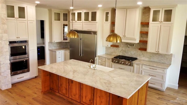 3417 Horizon Trl, Edinburg, TX 78541 - kitchen with stainless steel appliances, recessed lighting, light wood-style flooring, backsplash, and a large island