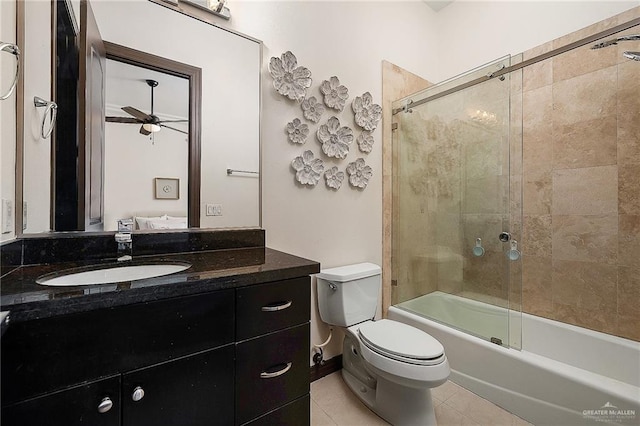 full bathroom with ceiling fan, tile patterned flooring, combined bath / shower with glass door, toilet, and vanity