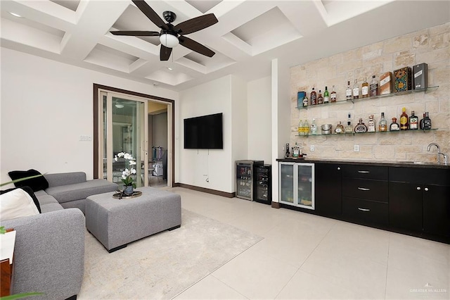 bar with beam ceiling, ceiling fan, sink, coffered ceiling, and light tile patterned floors