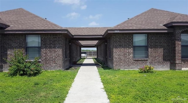 doorway to property featuring a yard