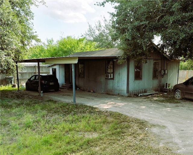 view of front of house with a carport and cooling unit