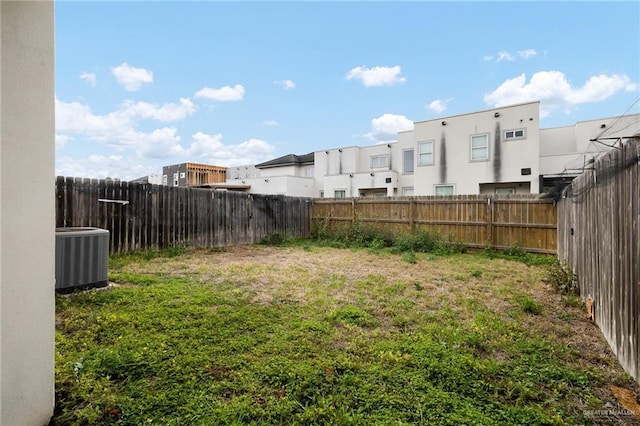 view of yard with cooling unit and a fenced backyard