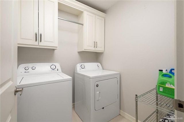 laundry area with washer and dryer, cabinet space, and baseboards