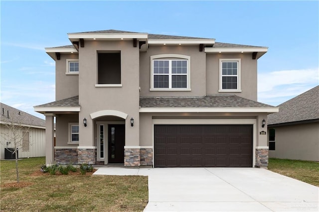 view of front facade with a front lawn, driveway, an attached garage, and stucco siding