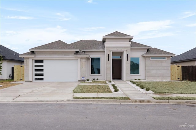 prairie-style home with a garage and a front yard