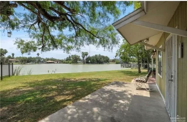 view of yard with a patio area and a water view