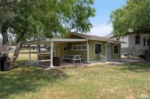 rear view of property with a lawn