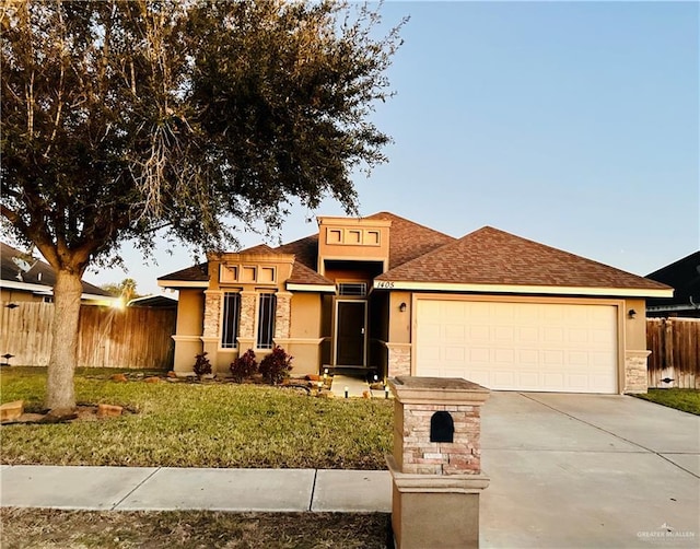 view of front of property featuring a garage and a front lawn