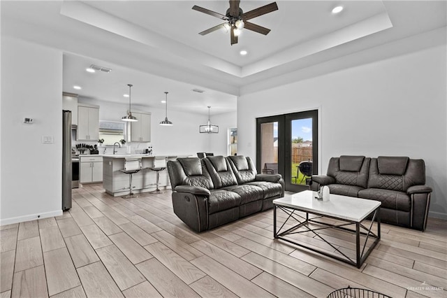 205 Faith Dr, La Feria, TX 78559 - living room with wood tiled floor, visible vents, a raised ceiling, ceiling fan, and recessed lighting