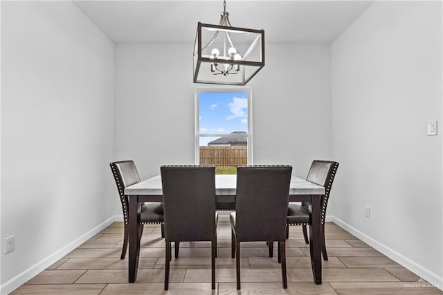 205 Faith Dr, La Feria, TX 78559 - dining space featuring an inviting chandelier, baseboards, and wood finished floors