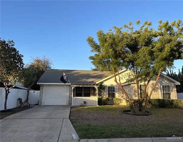 single story home featuring a front yard and a garage