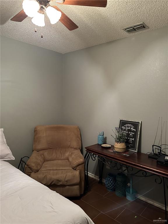 2104 Fairmont Ave, Mcallen, TX 78504 - bedroom with a textured ceiling, tile patterned flooring, and ceiling fan