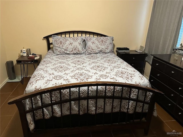 bedroom with dark tile patterned flooring