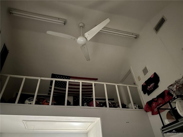 stairs featuring ceiling fan