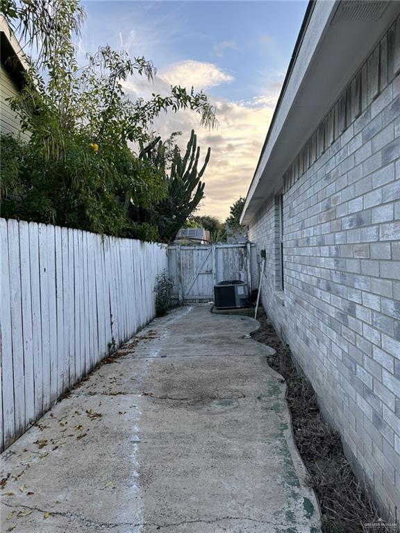 yard at dusk with cooling unit