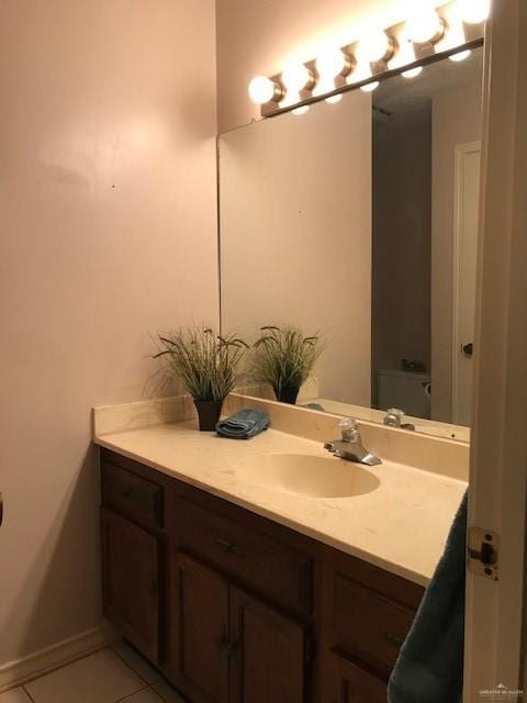 bathroom with tile patterned floors, vanity, and toilet