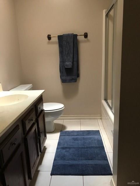 full bathroom with toilet, vanity, tile patterned floors, and combined bath / shower with glass door