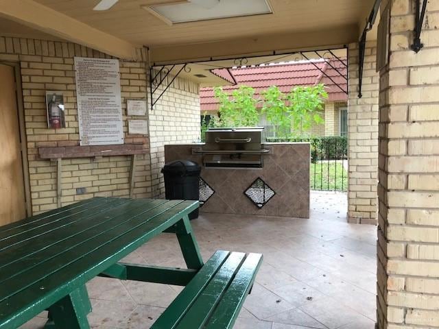 view of patio / terrace with area for grilling and ceiling fan