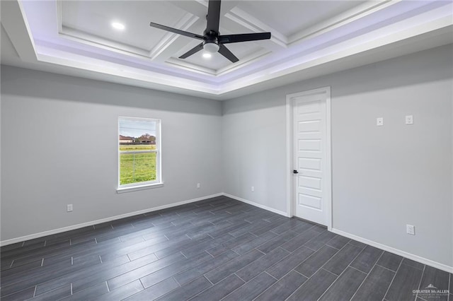 spare room with ceiling fan, beam ceiling, dark hardwood / wood-style flooring, and coffered ceiling