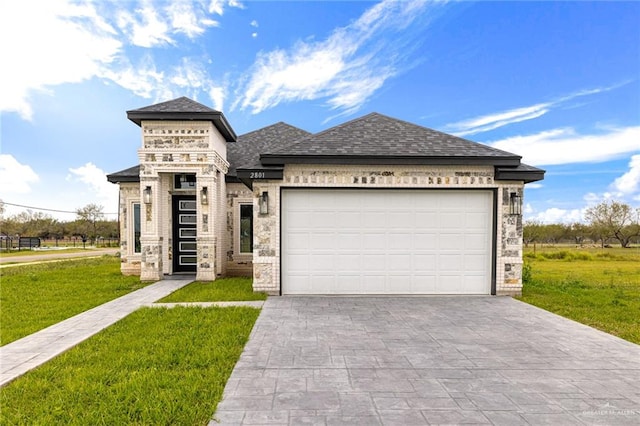 view of front of house with a garage and a front yard