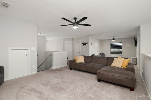 carpeted living room with ceiling fan