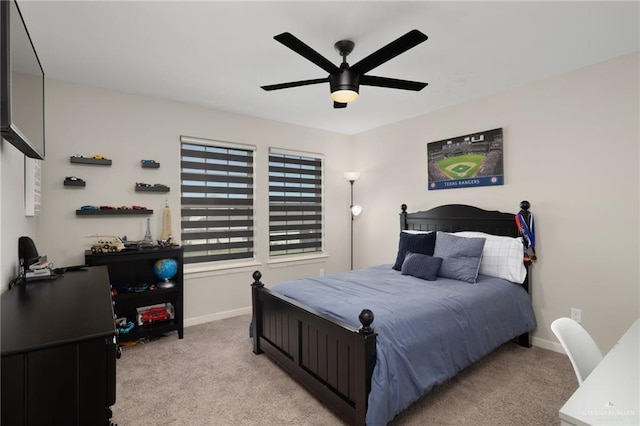 bedroom with ceiling fan and light carpet