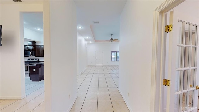 corridor with light tile patterned floors