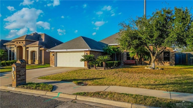 view of front of property featuring a front yard and a garage