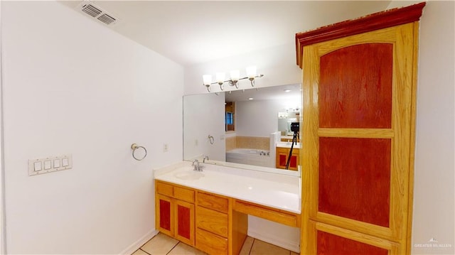 bathroom with tile patterned floors, a tub to relax in, and vanity