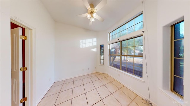 unfurnished room with light tile patterned floors and ceiling fan