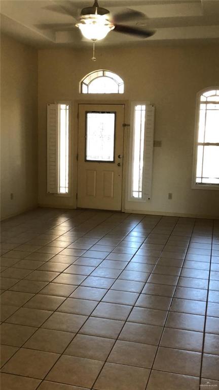 entryway featuring light tile patterned floors and a ceiling fan