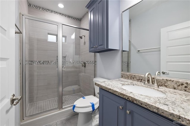 bathroom featuring walk in shower, tile patterned floors, vanity, and toilet