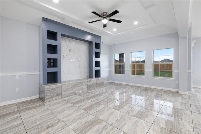 unfurnished living room featuring a tray ceiling and ceiling fan