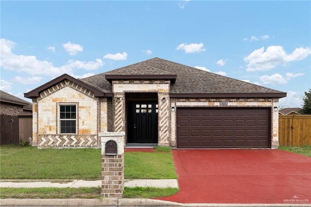 view of front of home with a front yard and a garage