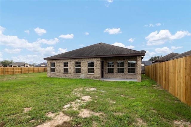 back of property featuring a yard and a patio area