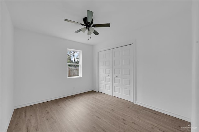 unfurnished bedroom with ceiling fan, a closet, and light hardwood / wood-style flooring